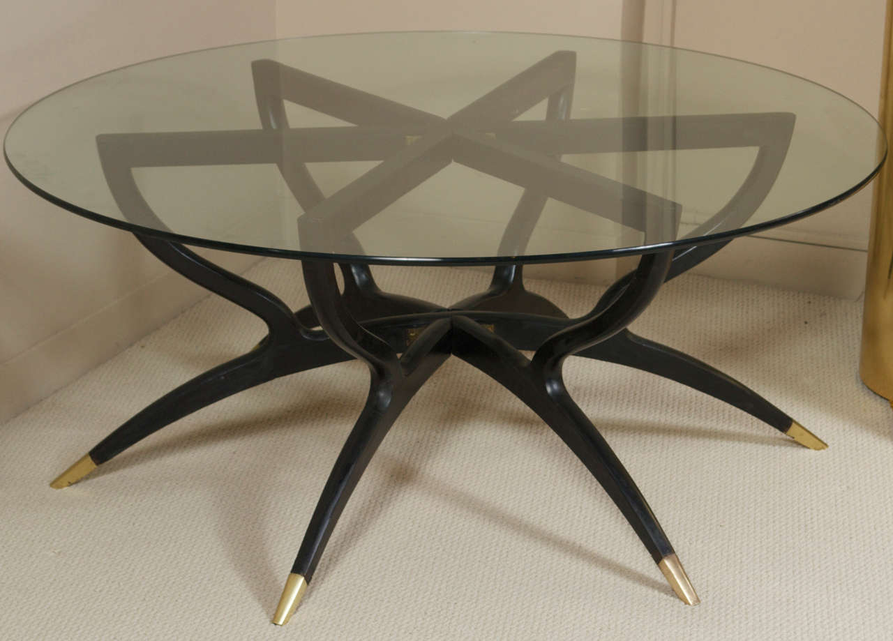 An interesting cocktail table with a folding, ebonized wood, spider-motif base with bronze details.  Italy - circa 1950.