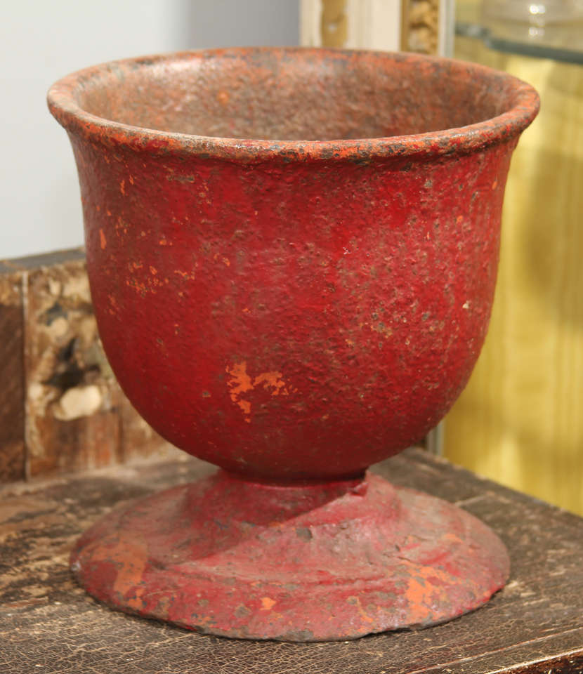 small scale French iron urn/ planter in original distressed red finish.  