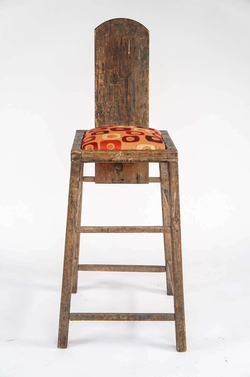 This tall and primitive chair with a modern upholstered seat.  A terrific form. A very modern dimension.