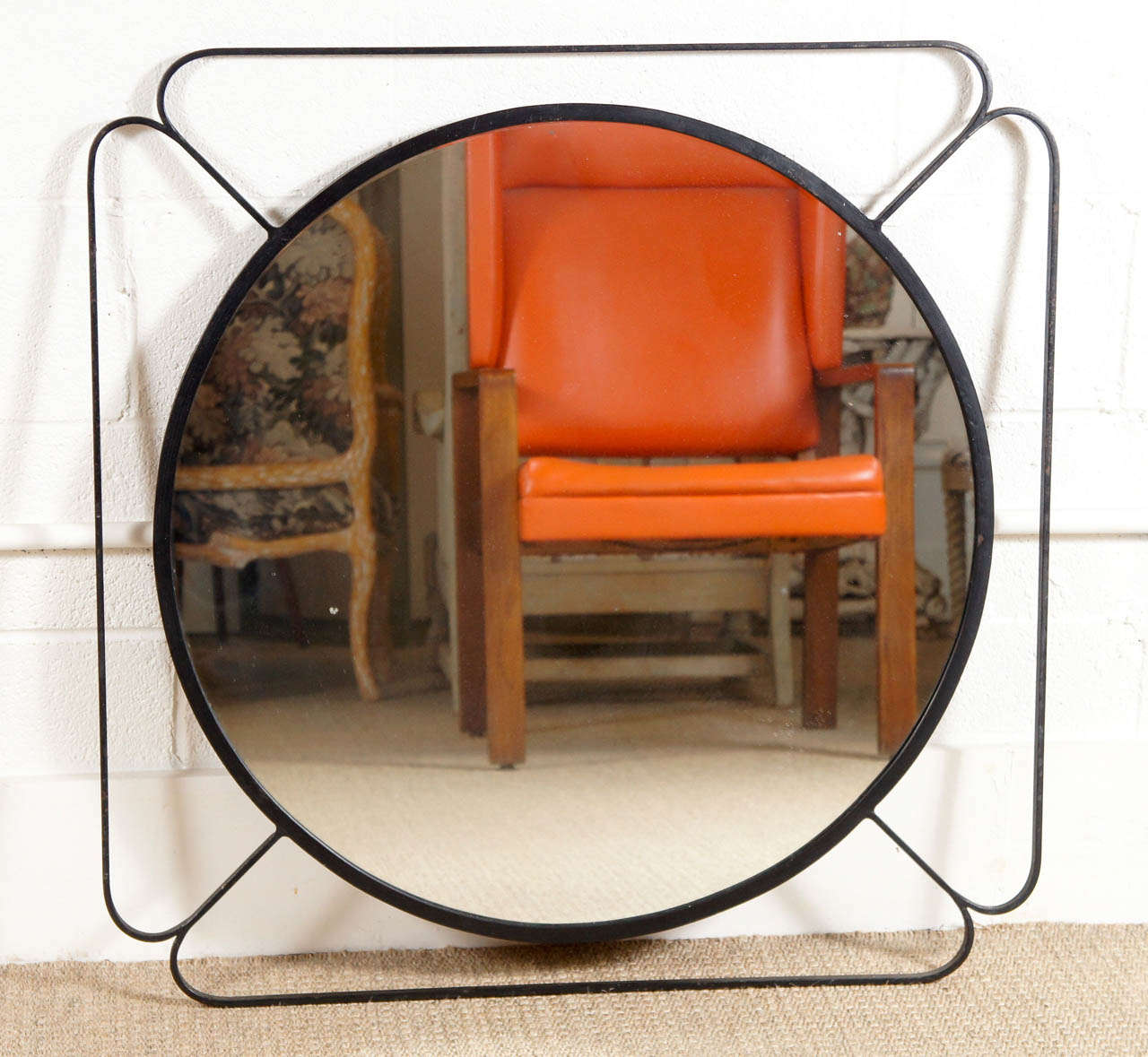 Here is a chic iron mirror with a circular center in a modified square.
Available as a custom order in one size only.