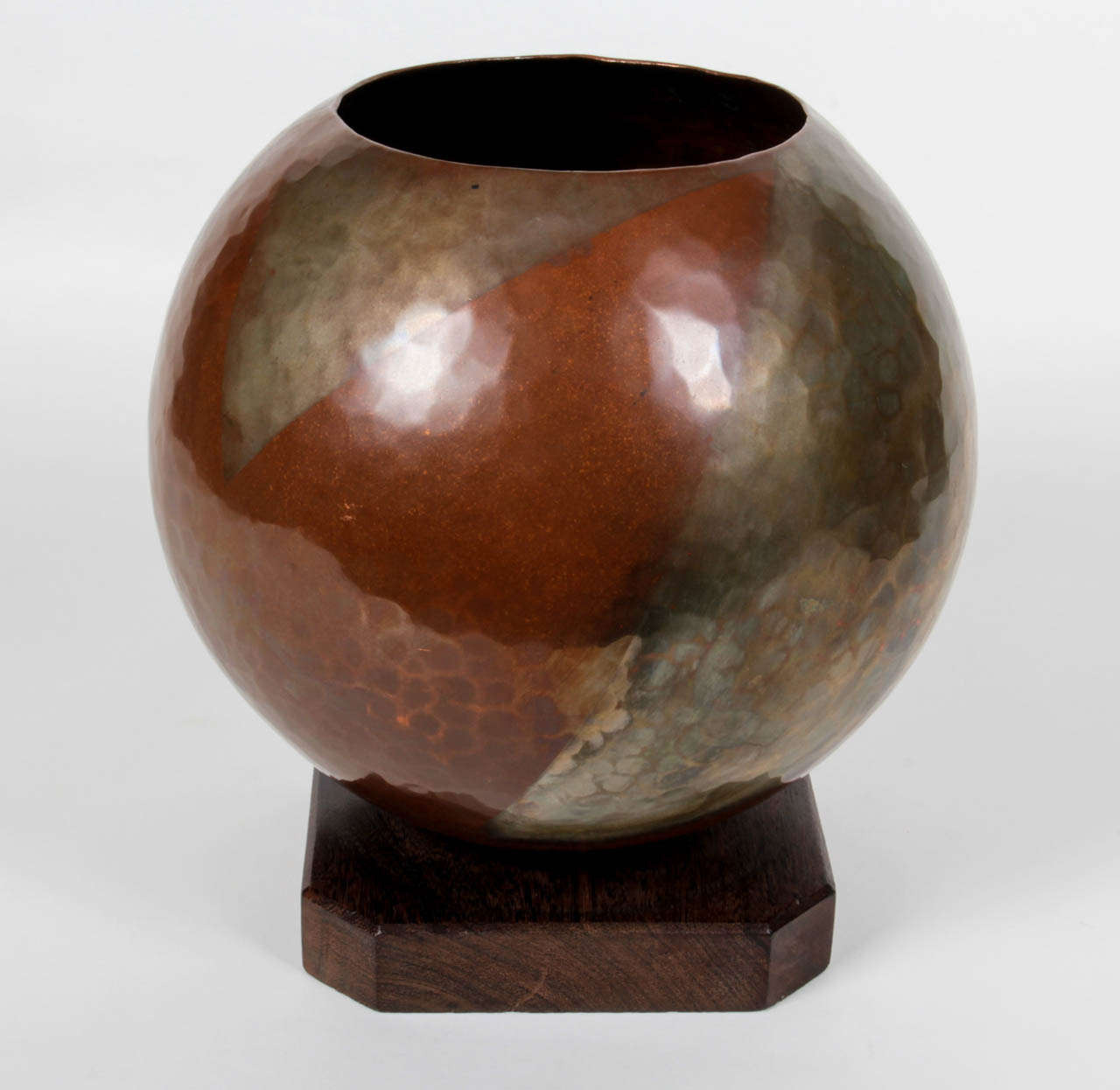 FRENCH ART DECO 

Dinanderie vase  c.1930

Richly patinated handwrought boule vase with a double large triangle silver overlay motif, square palm wood attached base

For more information see: Art et Décoration Revue Mensuelle D’Art Moderne,