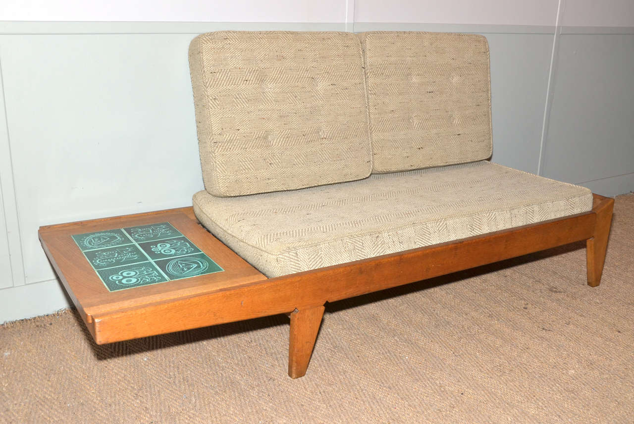 1950-1960's Guillerme et Chambron two seats bench sofa and daybed. Oak bench sofa with an independent sliding tray decorated with ceramic tiles. The tray can be removed leaving space for a cushion to convert the bench in a daybed. The sofa has no