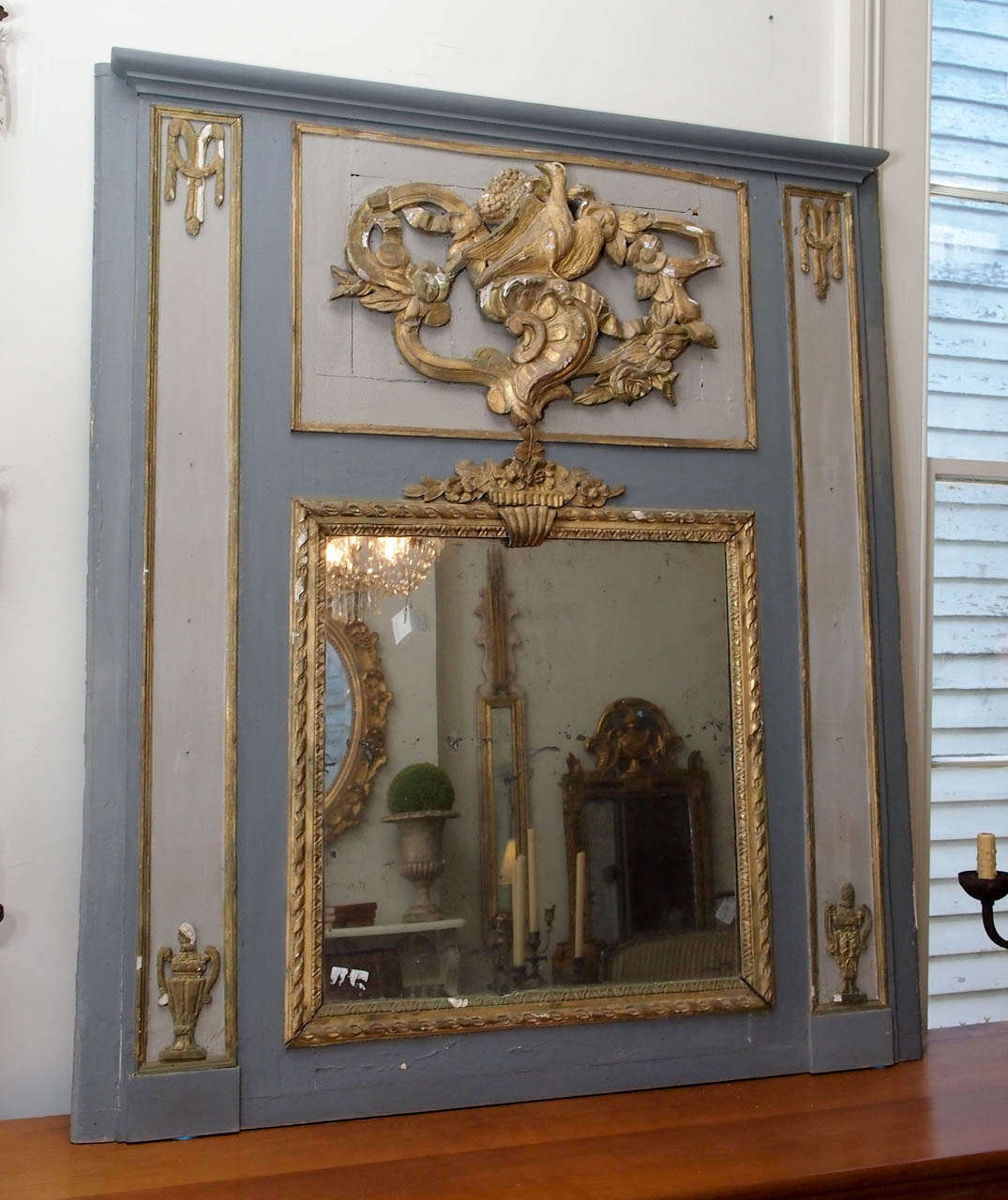 19th century trumeau mirror with carved gilt wood in a bird and flower motif and painted in blue and grey.