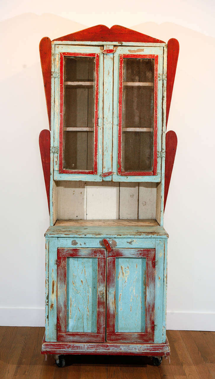 Painted wood cabinet, purchased in New Mexico, of pine and other woods, with wire screening inset in upper doors over interior shelves. Two lower, solid wood doors, over interior shelf of original, antique wood planks. Some minor professional