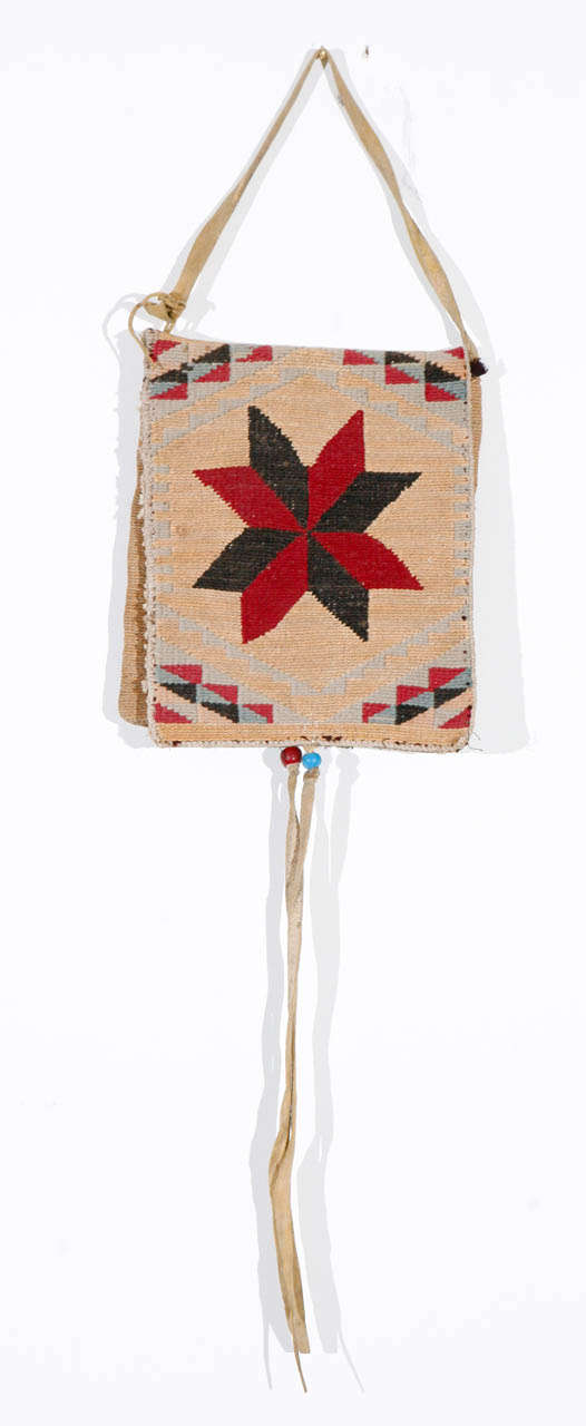 Woven corn husk bag in superb condition with deerskin handle and and ties. Different patterns on three sides, front, back, and inside flap. Two trade beads on top of fringe ties. Woven by the plateau tribes of the Columbia basin.
Note: Overall