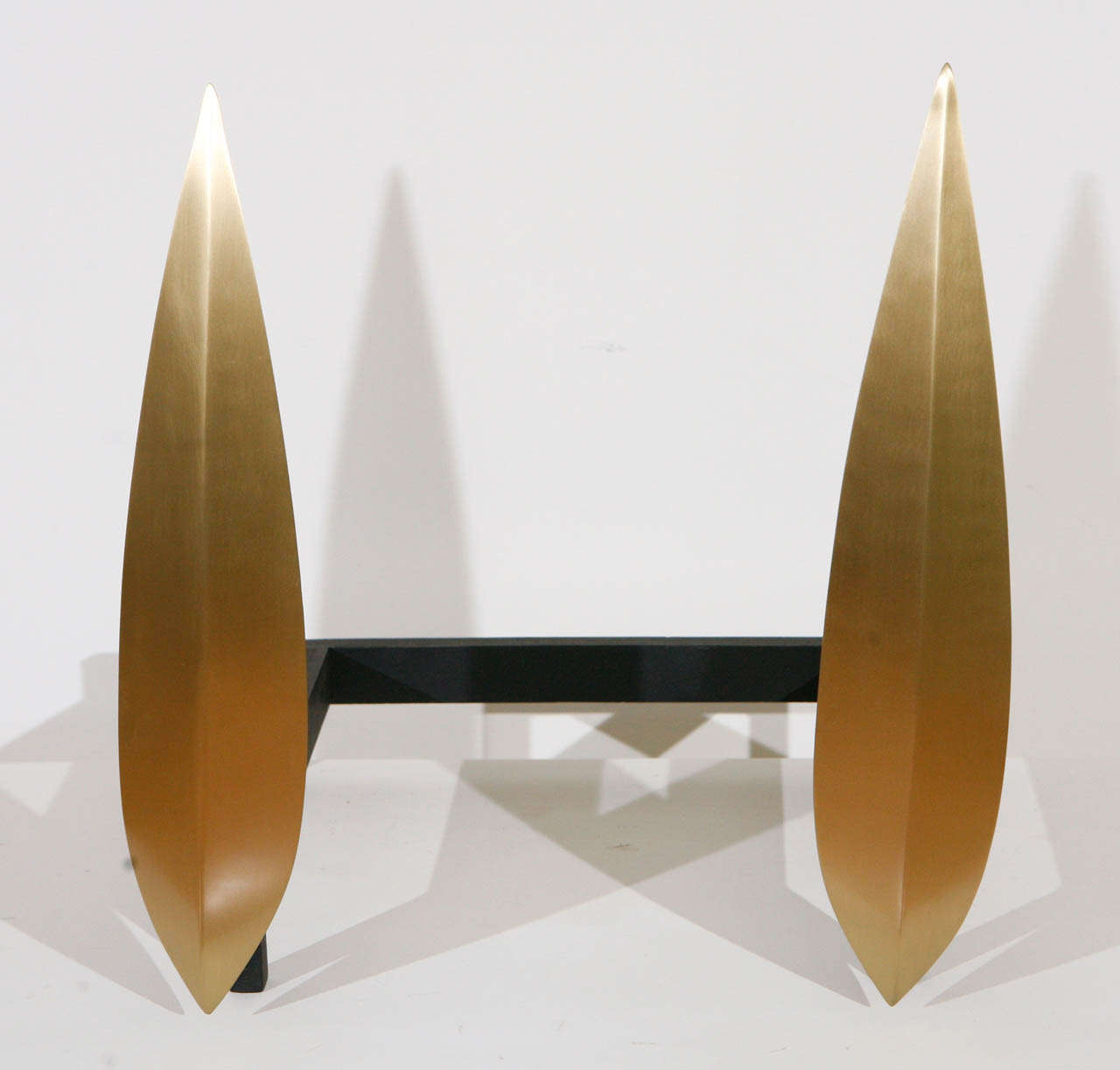 These sleek and ultra modern andirons by makers Drenttel Doyle Partners, formed as slender, satin brass spear points, are the perfect decorative touch to any contemporary style firebox.