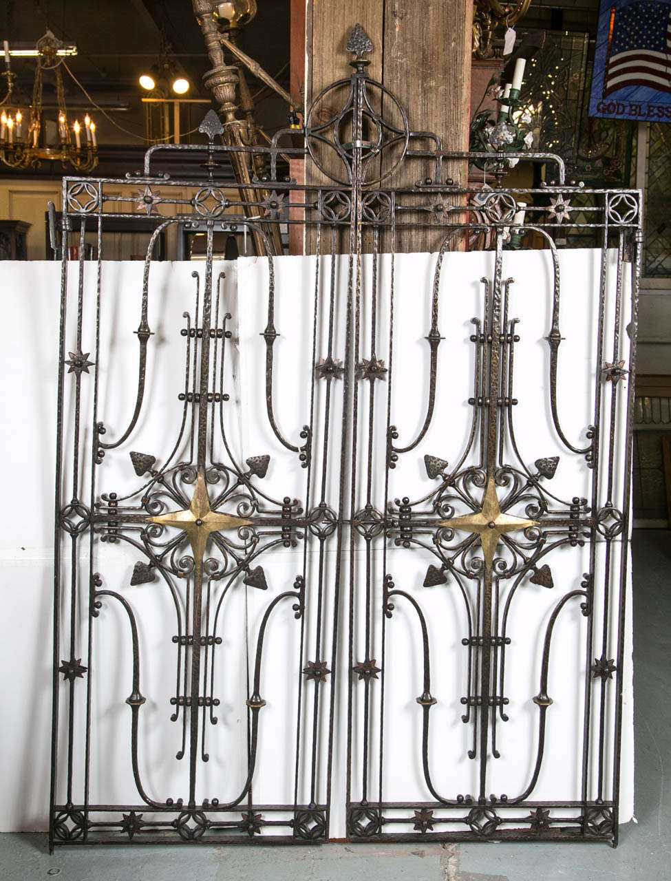 Architectural pair of star design wrought iron hand hammered gates. Have a flare of Tuscan Old World charm with a dash of medieval.  Gold tone star design and decorative scroll work at the middle of the gates make these unique gates special. Great