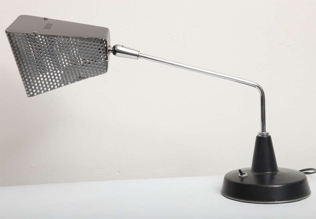 A 1960s Italian articulated table lamp by Stilnovo. chrome and perforated metal shade adjusts
New socket and rewired