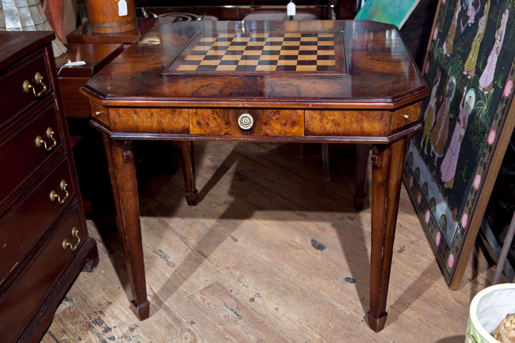 SQUARE GAME TABLE VENEERED WITH BRIARWOOD- DRAWER ON EACH SIDE-<br />
PULL OUT GLASS AND ASH TRAY BOARD ON EACH CORNER- FROM NEW YORK'S LANDMARK ALGONQUIN HOTEL LOBBY- CHECKERBOARD CENTER REVERSES TO GREEN LEATHER. INSIDE IS A BACKGAMMON INLAY BOARD