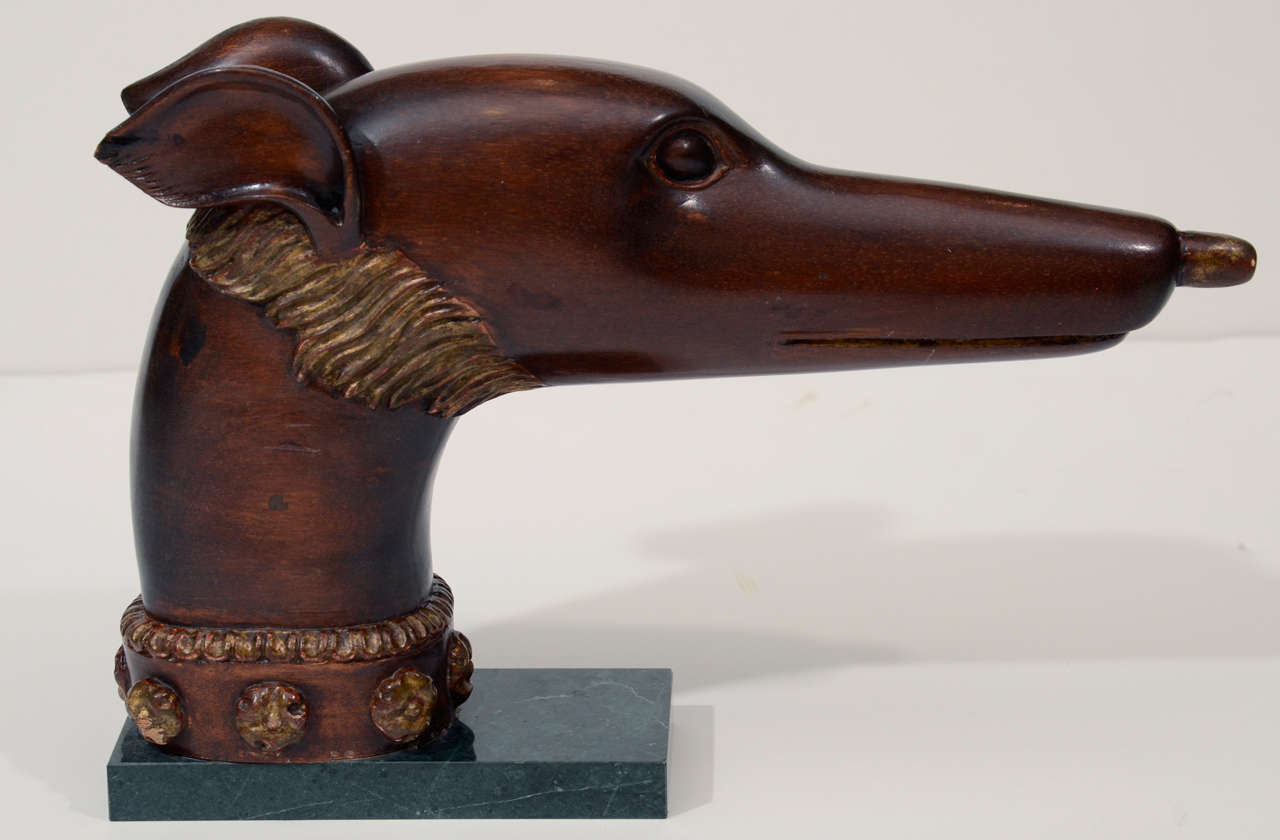 A beautifully carved mahogany surmount mounted on a marble base.
Italian, 1940's with parcel gilt detail.
