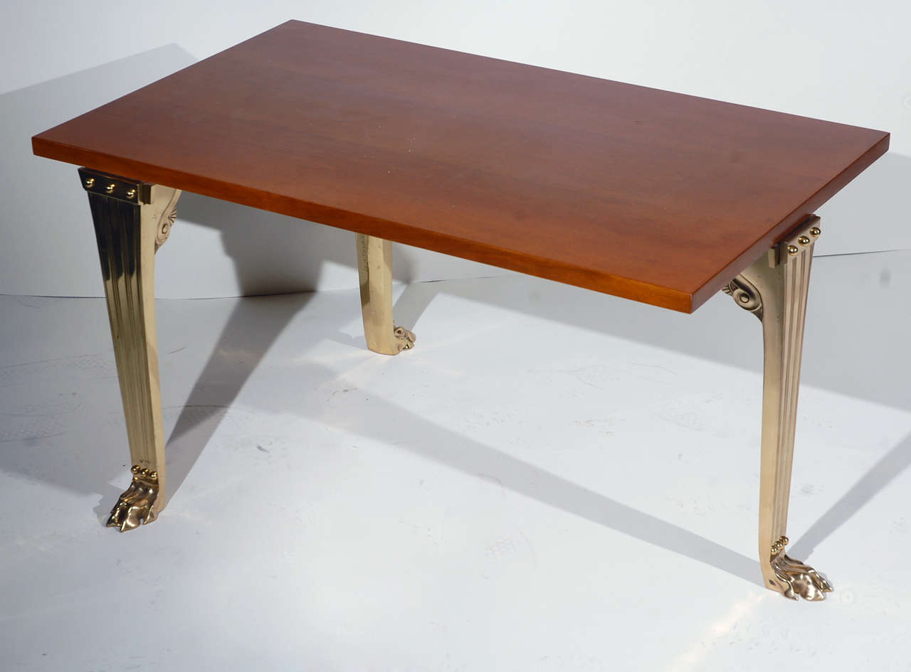 Robsjohn-Gibbings by Saridis Table # 10 with Greek walnut top and three bronze legs joined by stretchers.