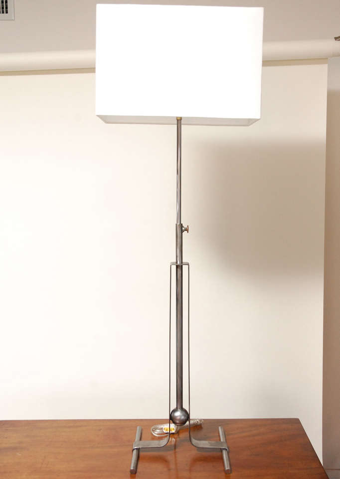 A very sleek and simple, modern pair of table lamps, circa the 1980's, that have the facility of extending to a greater height. The height down is 36