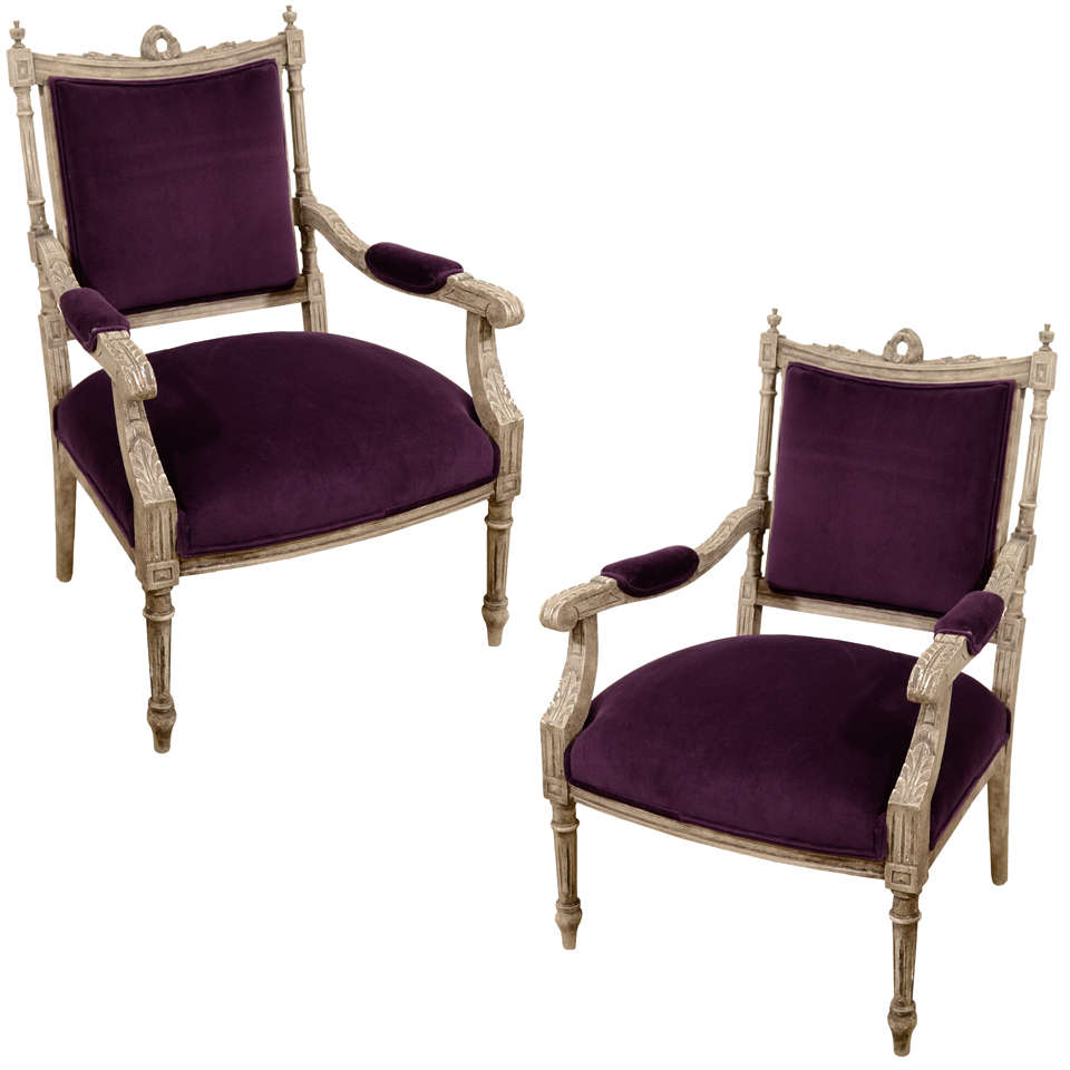 These armchairs are truly a blend of old and new.  These chairs were completely restored down to their 8 way hand tied springs and newly upholstered in a rich purple velvet fabric.  Beautiful Gustavian grey, hand carved frames with worn patina. 