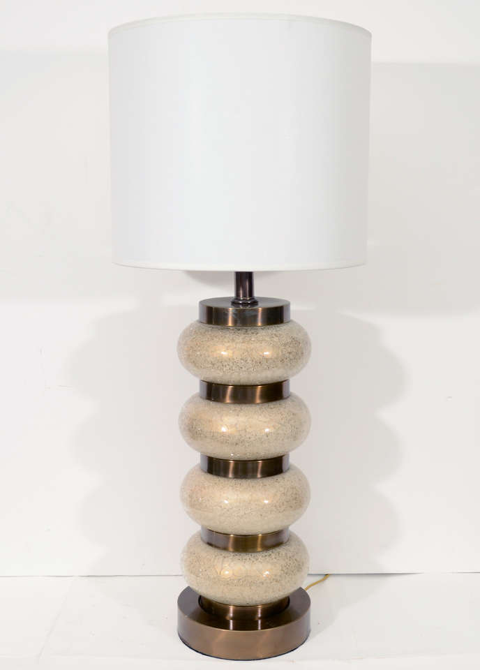 Fantastic pair of champagne metallic glass orb and brass disc lamps designed by Paul Hanson.