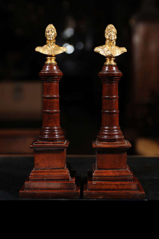 A pair of fine quality grand tour themed columns with gilt bronze bust surmounts.