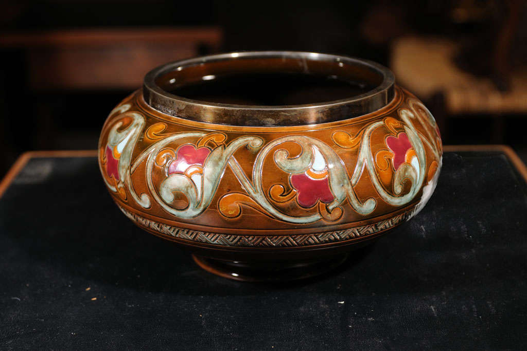 Christopher Dresser glazed ceramic bowl with sterling upper band with the Dresser stamp produced by Linthorpe pottery.