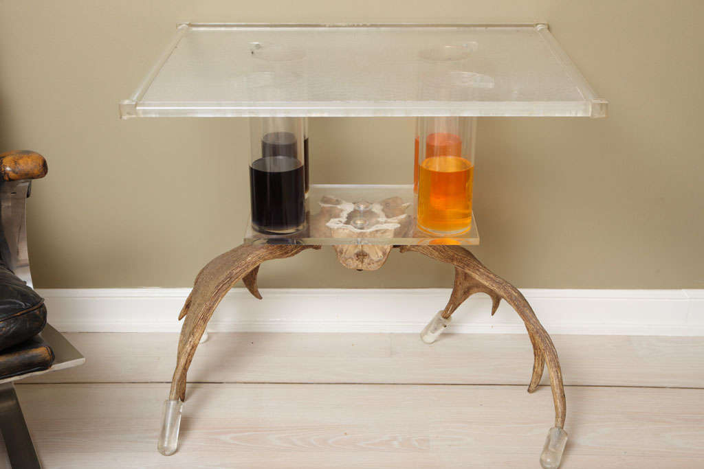 Fantastic and unusual table of contrasting materials; lucite, antler and colored oil!