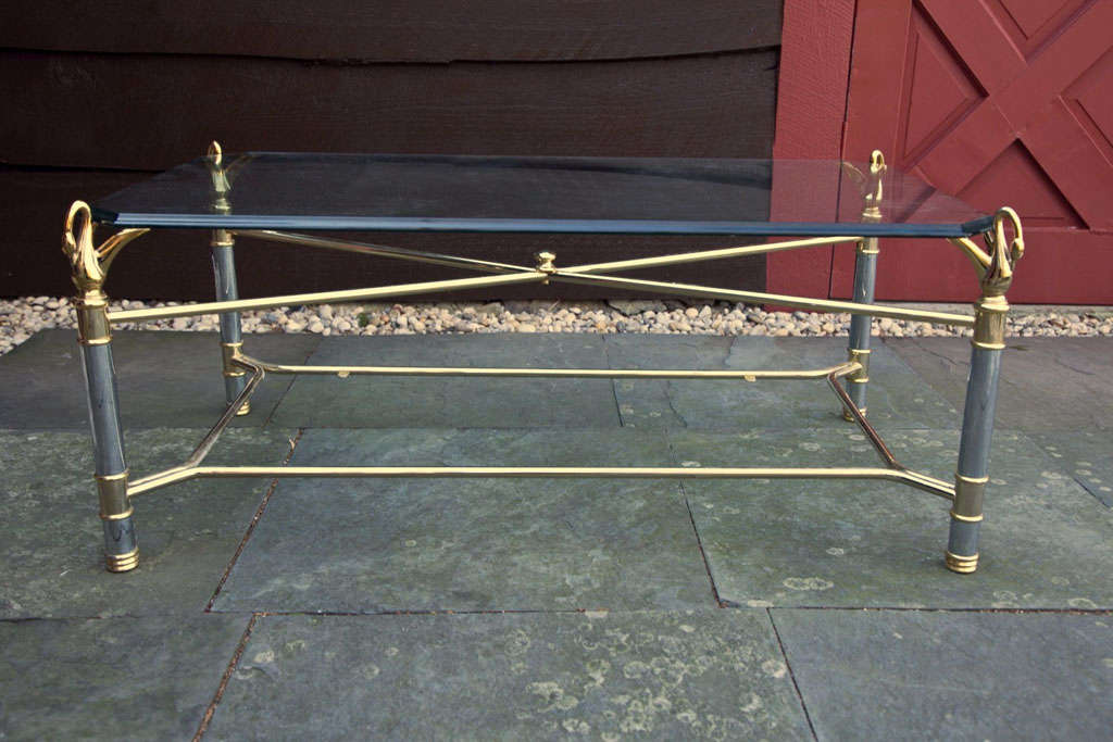 Chrome and brass swan mounted coffee table with glass top attributed to Maison Charles.