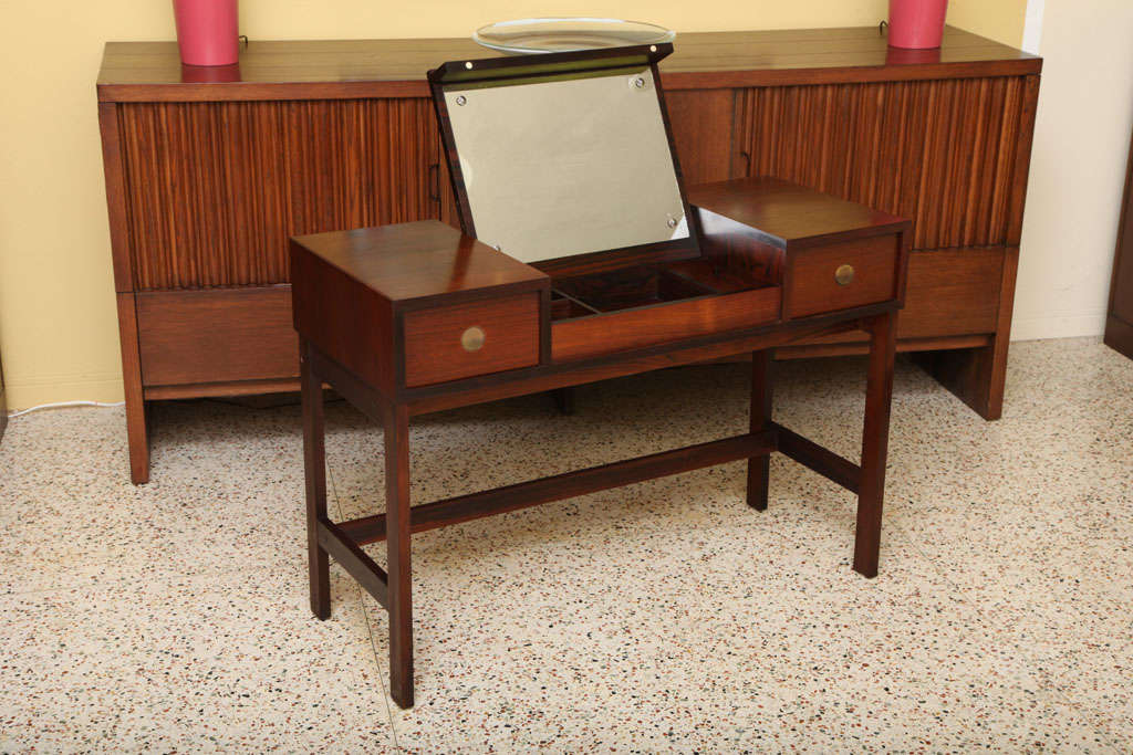 ...SOLD FEBRUARY 2012...Nicely finished in Brazilian rosewood, this vanity or dressing table by noted Danish cabinetmaker Dyrlund has a sleek styling and compact profile and footprint.  The rectangular body has a drawer to the left & right and a