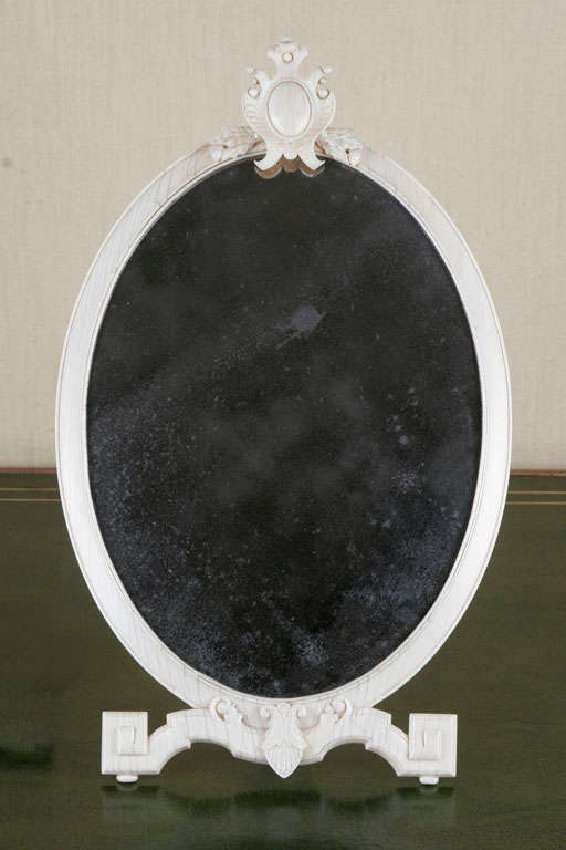 A Louis XVI Oval Ivory Dressing Mirror