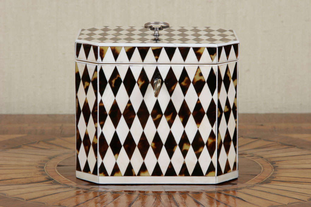 A rare late eighteenth century Harlequin tea caddy, veneered throughout with Ivory and tortoiseshell diamond lozenges. The lid opening to a single lidded compartment with further harlequin decoration, retaining much of its original lead lining. With