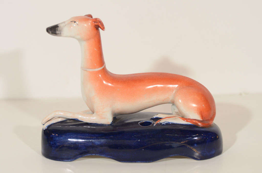 Early and original inkwell or quill pen holder in the form of a seated greyhound by Staffordshire. England, circa 1860.



Features a finely executed seated pose with meticulous hand painted detailing.