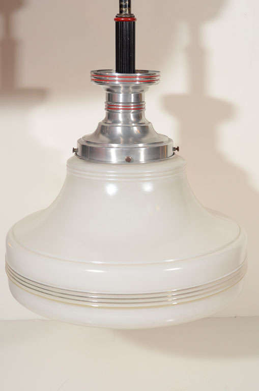 Vintage industrial-style ceiling light fixture with brushed metal hardware and white glass shade.  USA, circa 1950.