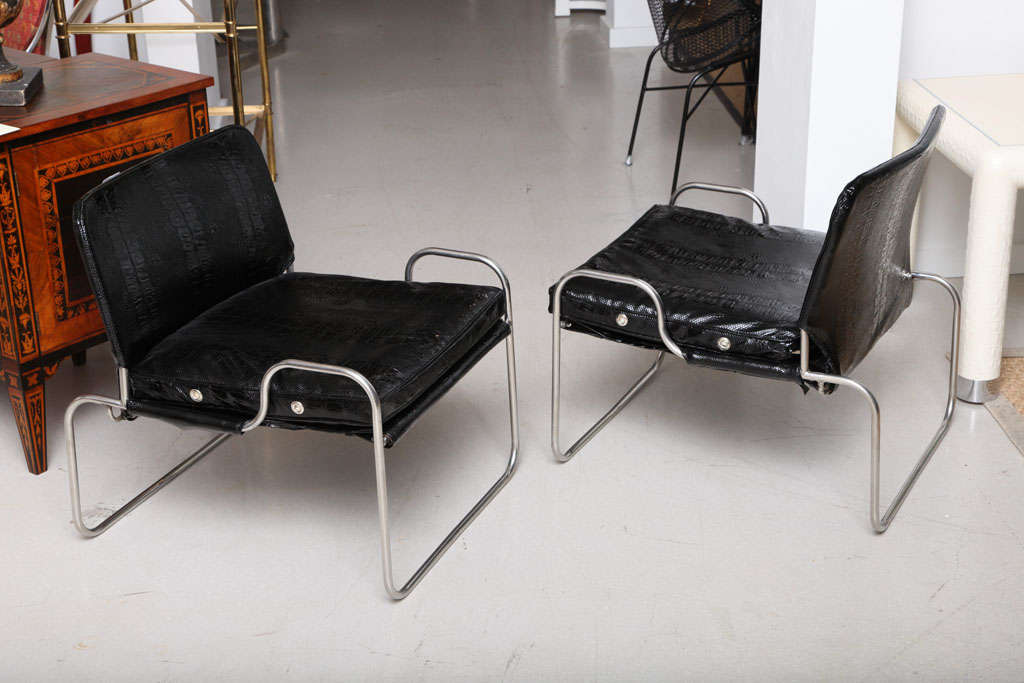 Pair of Bauhaus style tubular low chairs with black patent leather cushions.