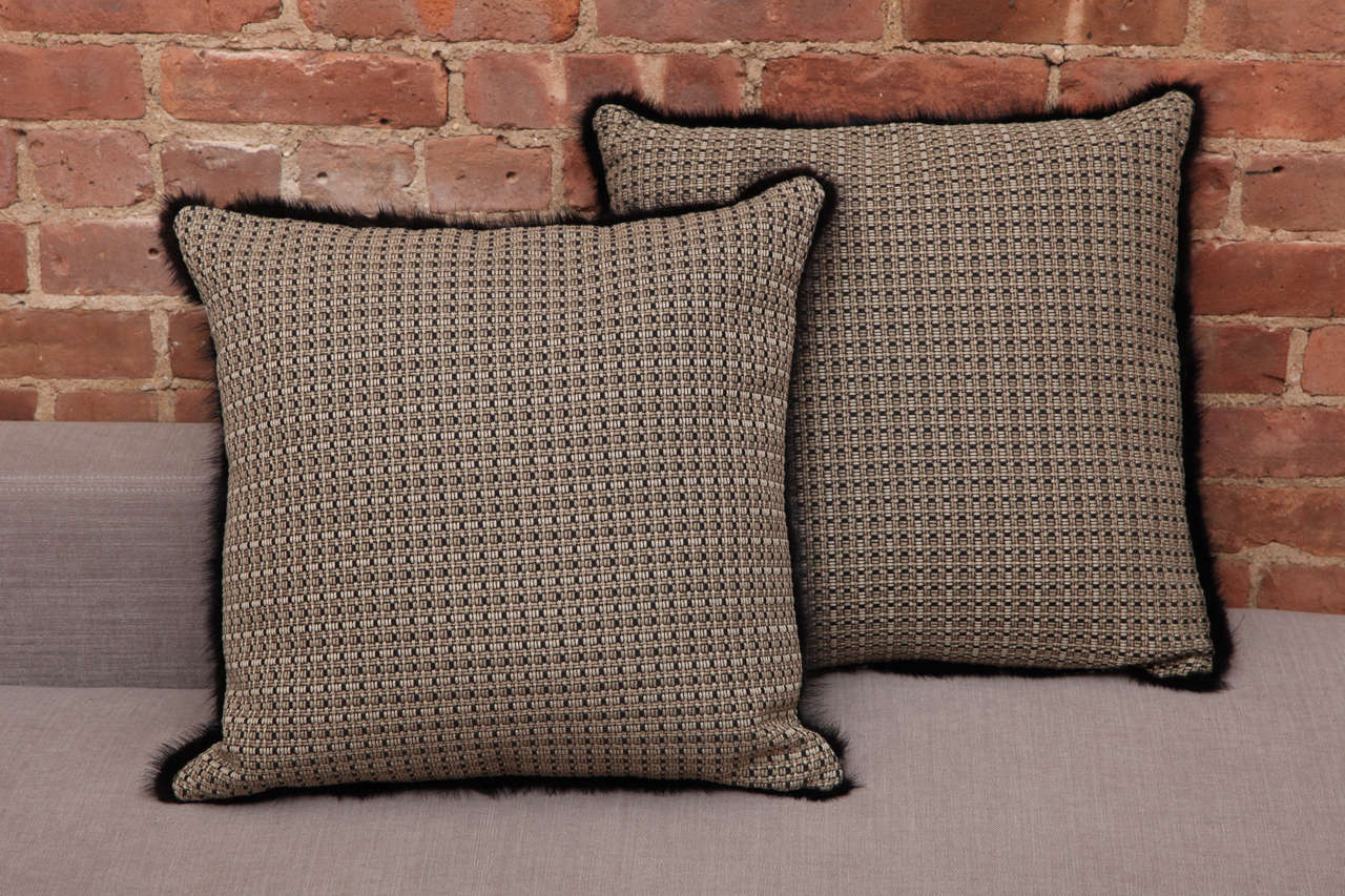 The original British Jacquard weaves textile is complemented by the black fur trim that brings a chic and a warm touch to the pillow as a decor piece.
The one of a kind pair of pillows were designed and made in NYC by Arlene Angard Designs.
Down