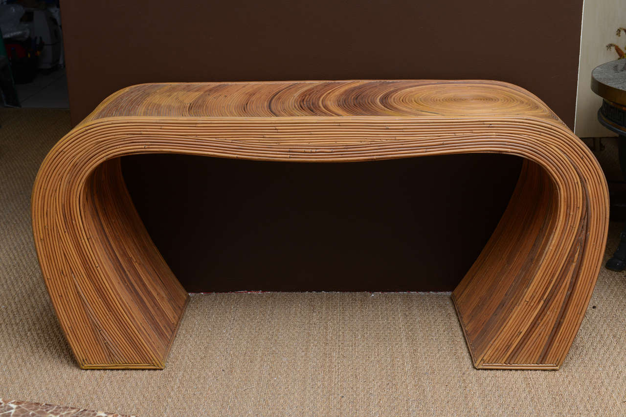 A Mid-Century caned bamboo, entry hall console table. Handmade, with a swirl pattern and inward curved sides.