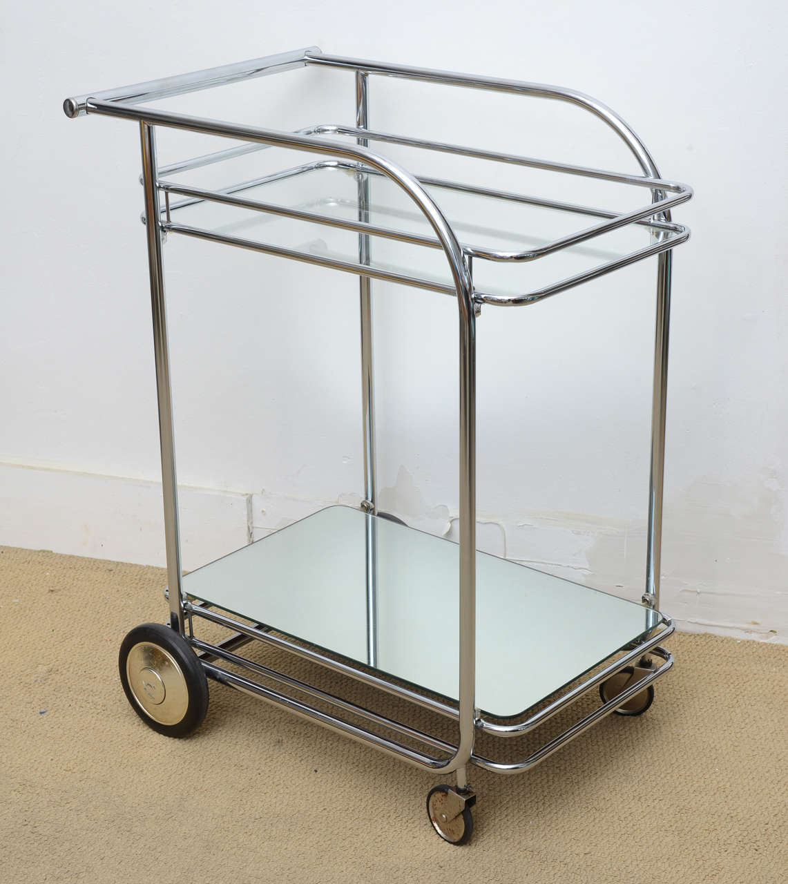 This all original Art Deco style serving or bar cart I believe dates back to the 1960s. However there is a possibility it could date back to early decades. During the sixties there was an Art Deco resurgence that's why I believe this to be from that