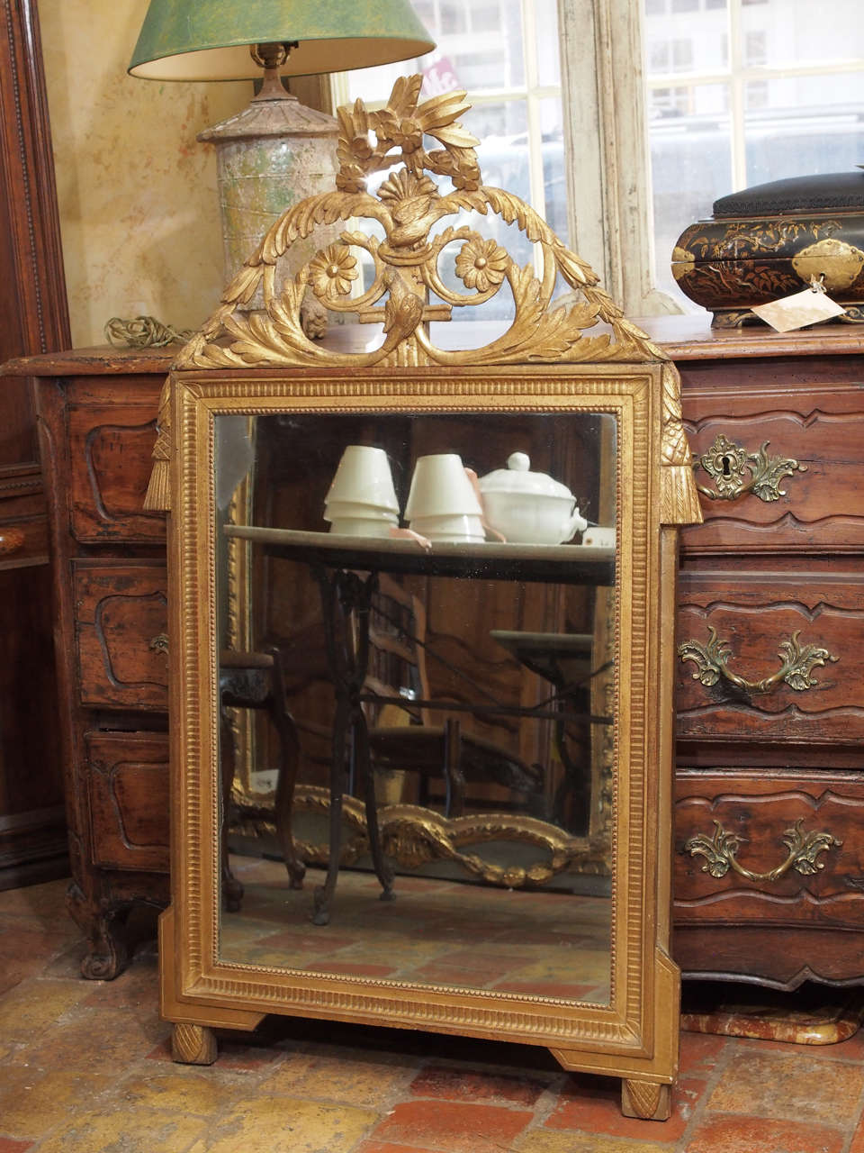 18th century French Louis XVI hand-carved giltwood mirror with acanthus leaves, flowers, pine cones and tassels.