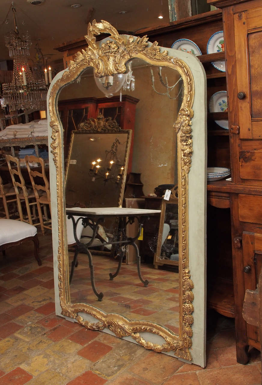 19th century French Louis XV-style painted (light blue) wooden gilded mirror with carving. From a Brasserie, circa 1840.

Measures: H 72¼