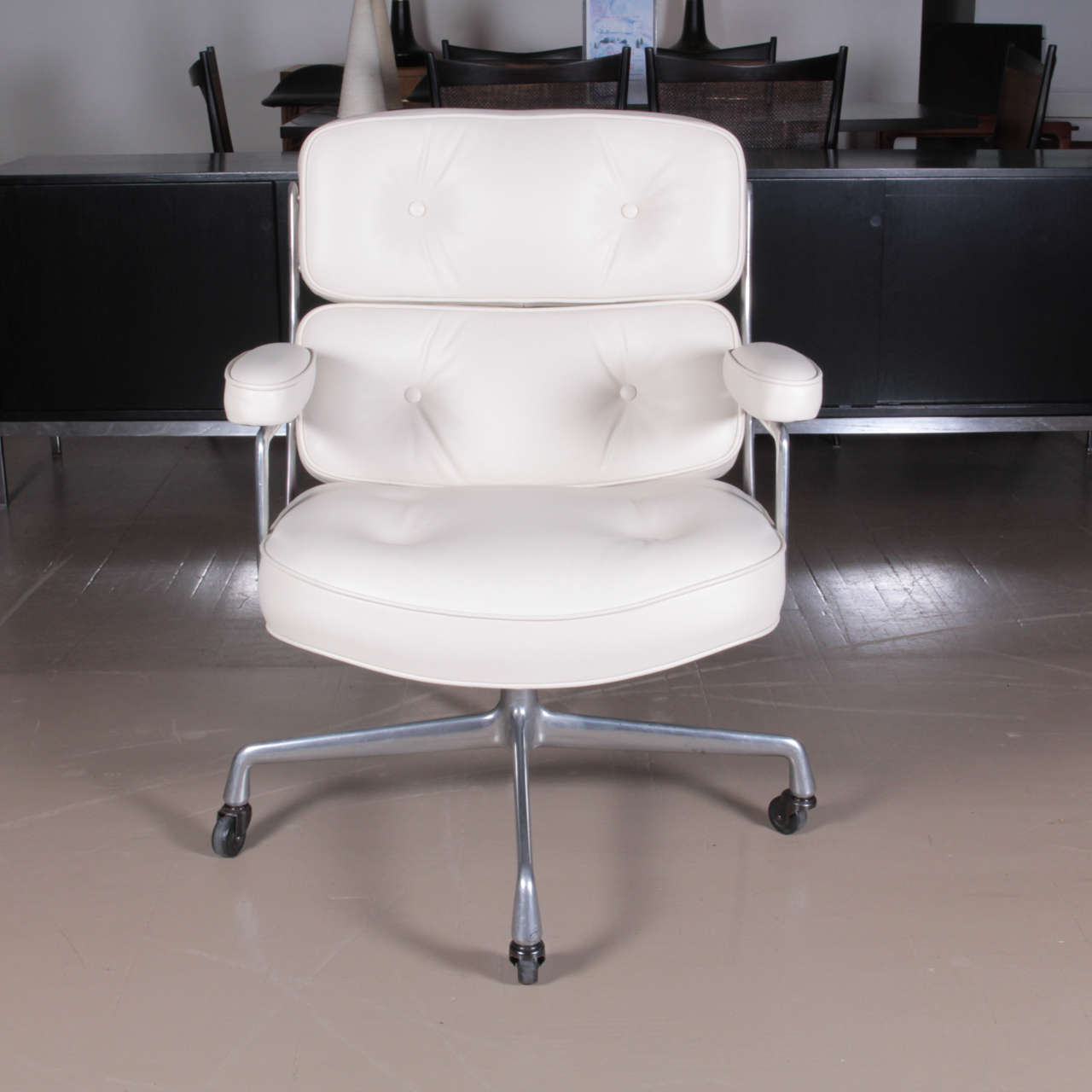 Adjustable height desk chair with cast aluminum frame on casters with new cream colored leather upholstery designed by Charles Eames for the executive offices in the Time-Life building in New York City in 1960 and produced by Herman Miller.  This is