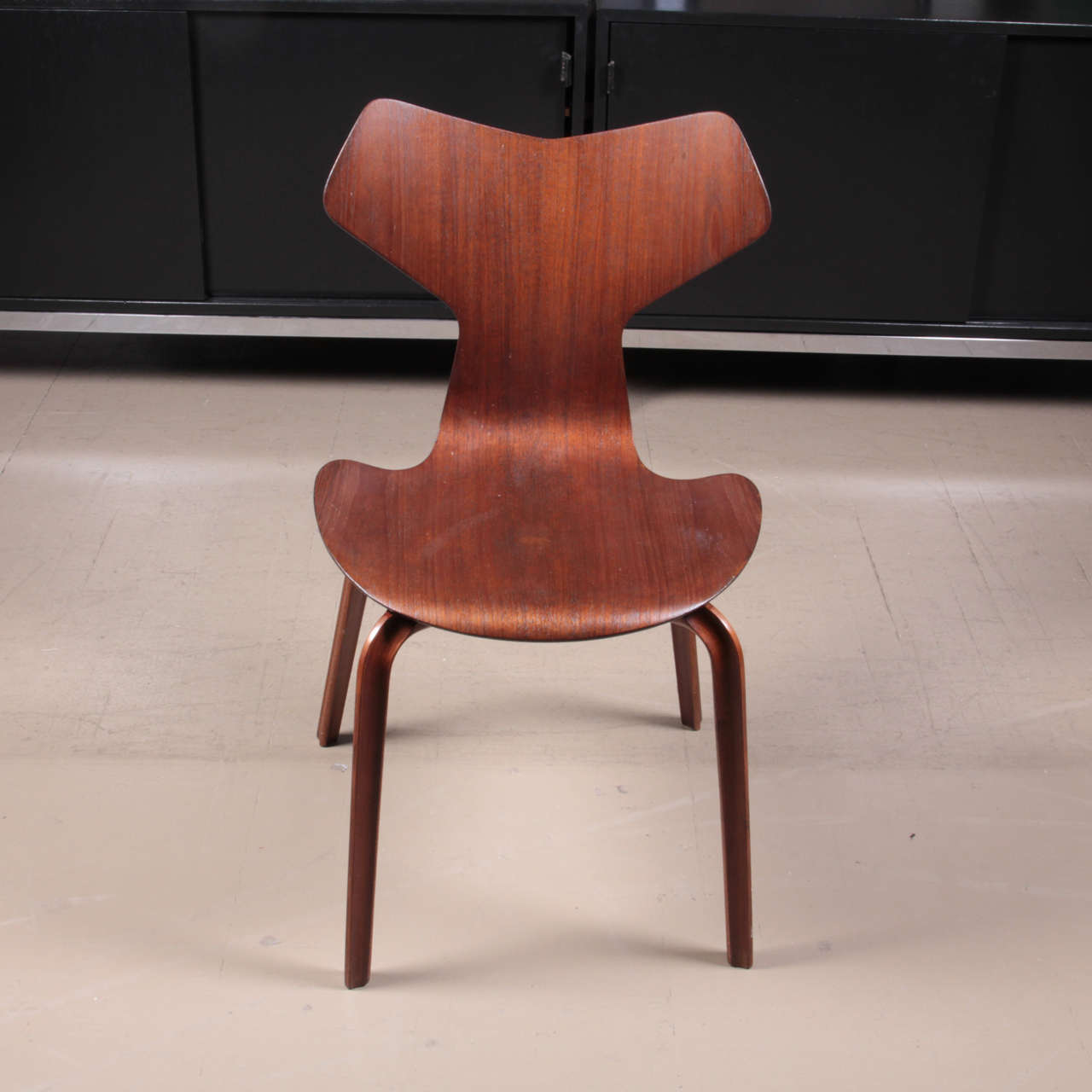 Pair of teak dining chairs designed in 1957 by Arne Jacobsen and subsequently called the “Grand Prix” chairs after winning the prestigious award at the Milan Triennale the same year. Manufactured by Fritz Hansen in Denmark. This version of the chair