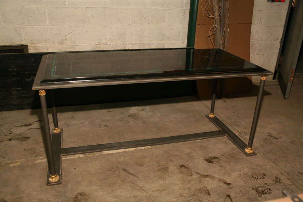 This table made of hand forged Iron with gilt bronze embellishments is topped with a fine Saint Helena Black marble top, inlayed with Malachite and Lapis line work. The form taken from ancient ideals used in Rome has here been presented in a more