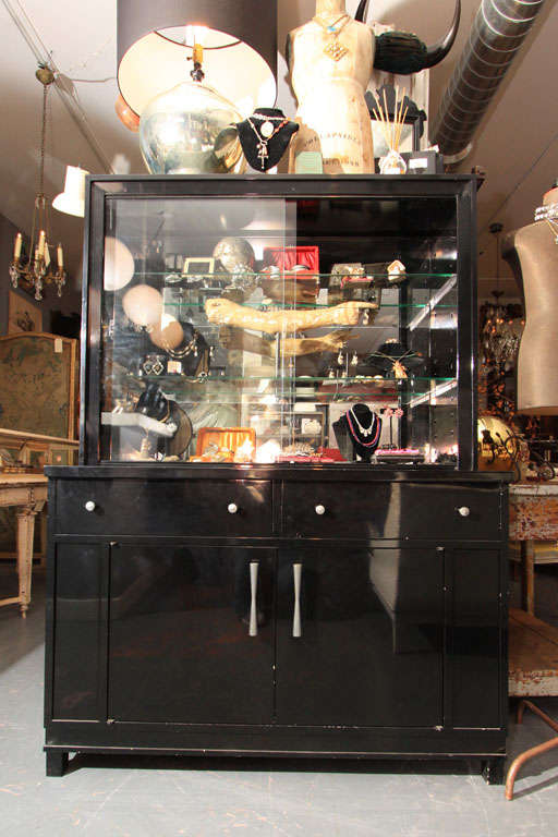 Black metal cabinet by Okamura. Sliding glass doors with two adjustable glass shelves.