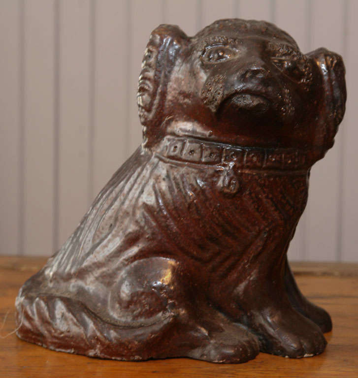 sweet sculpted dog with collar<br />
deep reddish chocolate brown<br />
sewer tile folk art from PA