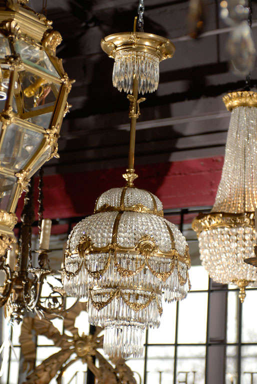 Petite gilt bronze and crystal French chandelier, height is adjustable.