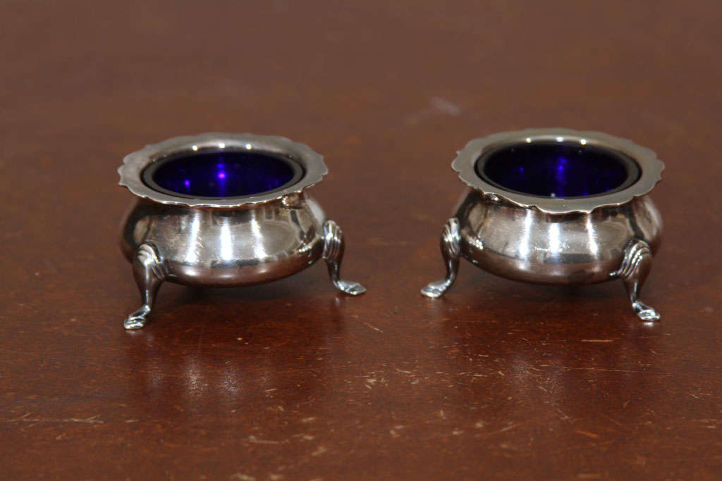 Pair of English sterling silver salt cellars with removable cobalt glass inserts. Hallmark on bottom.