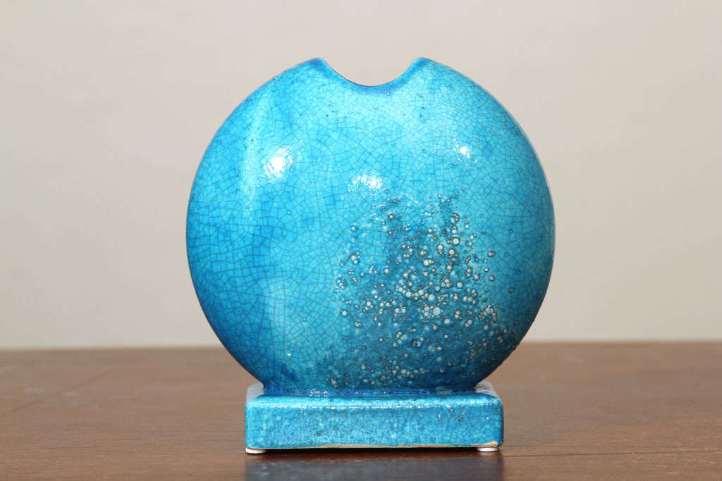 Turqoise crackle glaze ceramic round vase on square base. The mark 