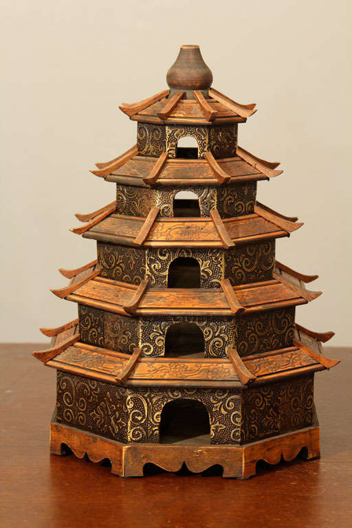5 level Chinese or possible Japanese Pagoda Bird House. Sides are are embossed pressed tin or pop metal sheets. Roof tops have carved designs. Slight repair made to edge of one section of roofline-2nd to top section.