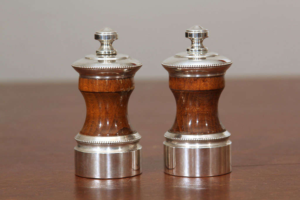 Very handsome set of two salt and and pepper grinders. Hallmark stamped on bottom.