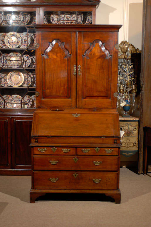 A walnut bureau bookcase with blind arched paneled doors.