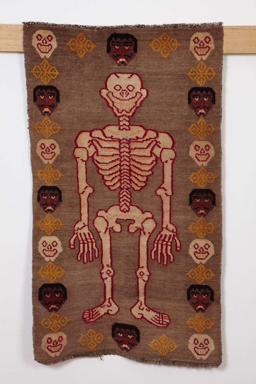 A rare example of Tibetan tantric rug, employed by Vajrayana Buddhists as seats of power during the practice of esoteric rites associated with protective deities. 
The peculiar imagery depicted in these rugs symbolize the power of detachment from