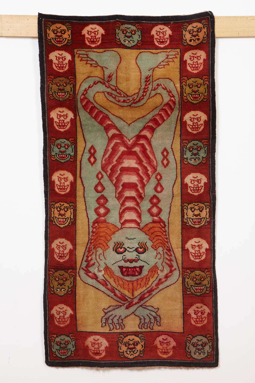 A rare example of Tibetan tantric rug, employed by Vajrayana Buddhists as seats of power during the practice of esoteric rites associated with protective deities. 
The peculiar imagery depicted in these rugs symbolize the power of detachment from