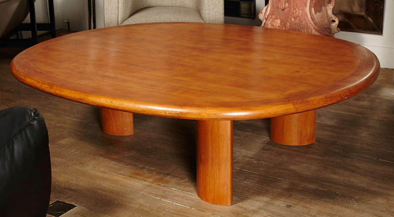 A large and decorative coffee table in massive cherry wood, 
The thick tray supported by 3 feet.
France circa 1960