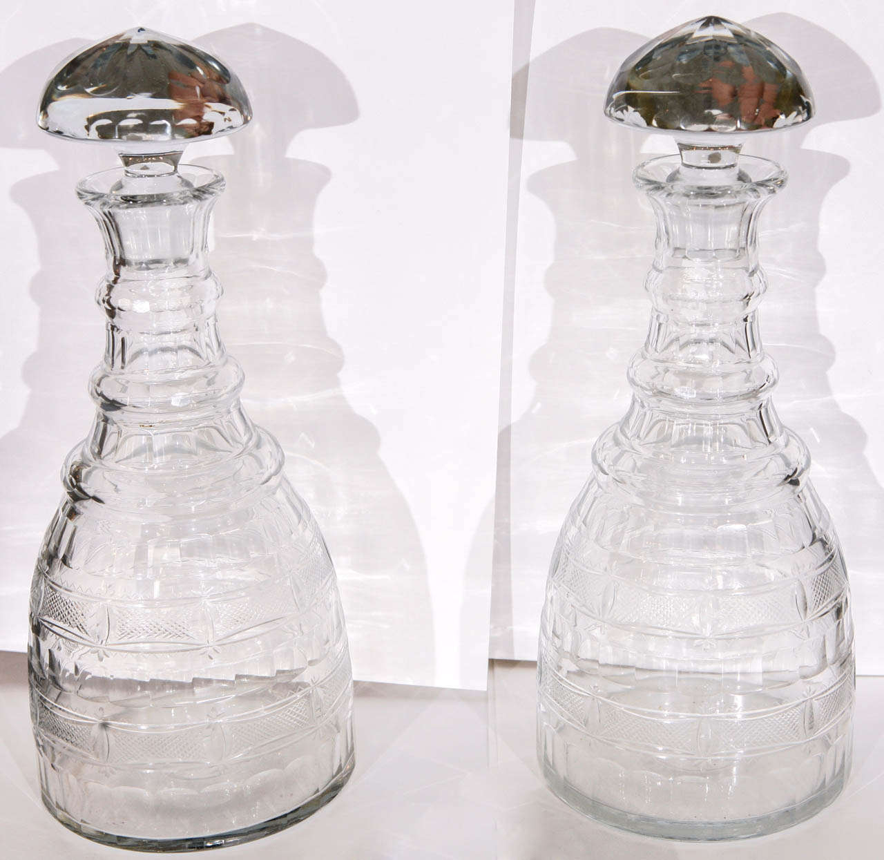 A Pair of Cut and Engraved Decanters with distinctive Mushroom Stoppers, England,
early 19th c.