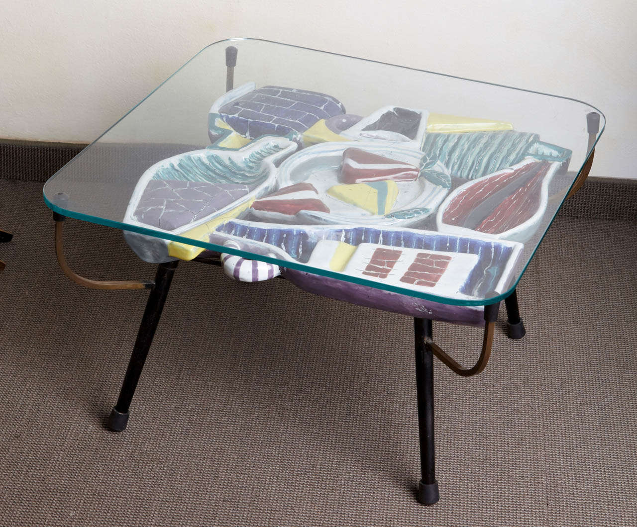 Low table with polychromed ceramic decor under the top glass.
Signed under the base,
Venice, 1960s.
