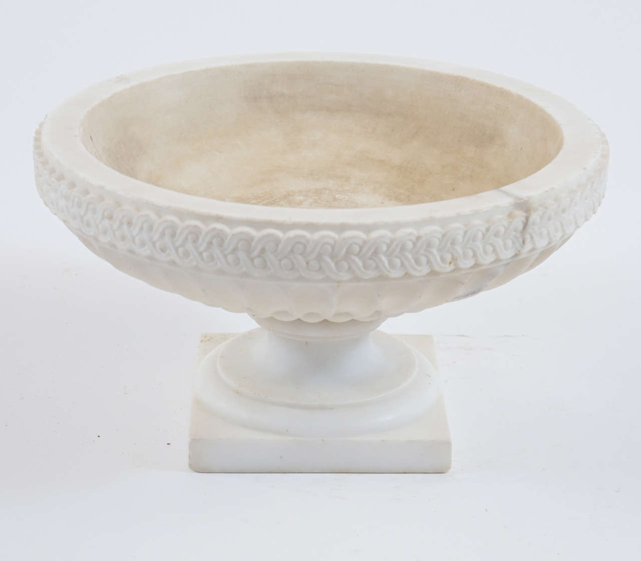 Exquisite large Italian statuary marble urn of tazza form having carved interlacement band surmounting gadrooned stop-fluted basin on socle base.
